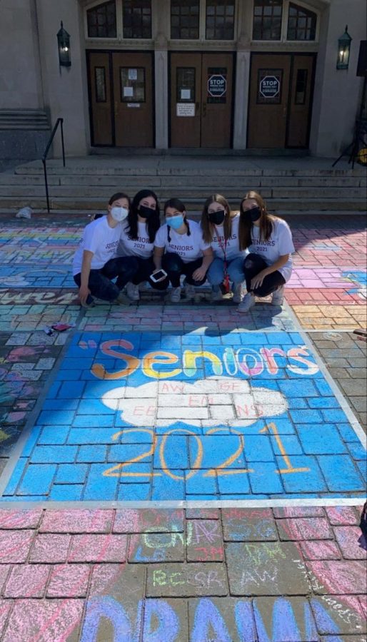 Students using their creativity and artistic abilities during the senior chalking event.