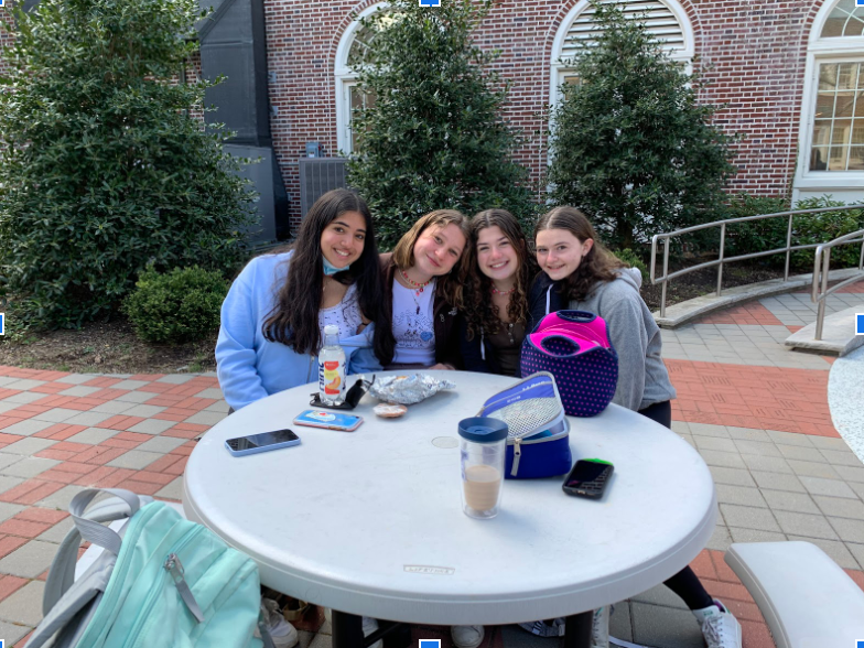 SHS students enjoying lunch in the courtyard on a sunny day. 