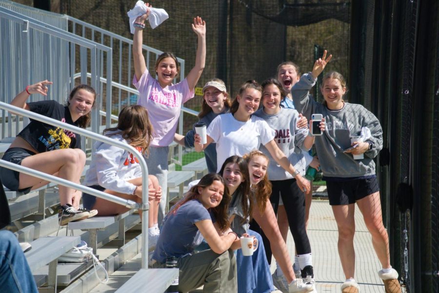 The girls lacrosse team cheering the boys on.