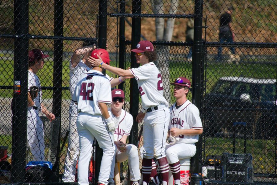 Luke Williams congratulating Pat Carroll after he scores the only run of the game.