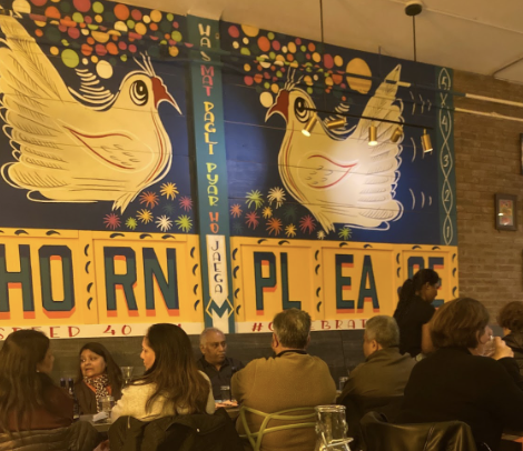 The colorful murals painted on the walls combined with the bright yellow lighting make for a warm and welcoming atmosphere.