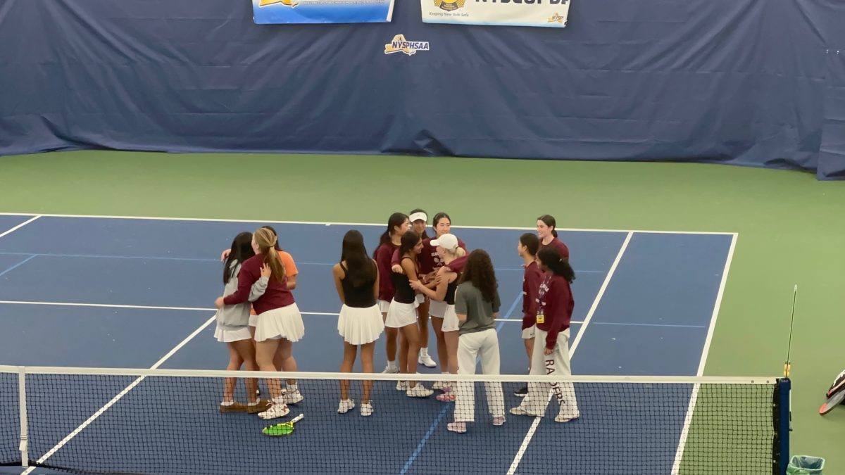 The Girls' Varsity A Tennis Team celebrates their win on the courts where the final match was played.