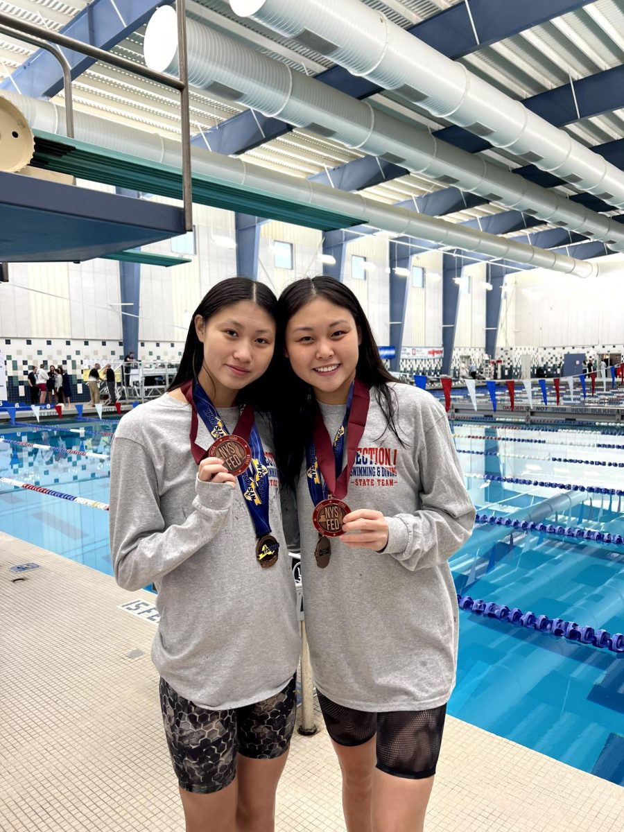 Sunny Kang (left) and Joy Kang (right) posing with their medals.