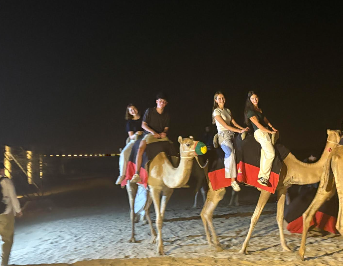 The SHS students at the opening dinner, riding camels at Fort Dubai. 