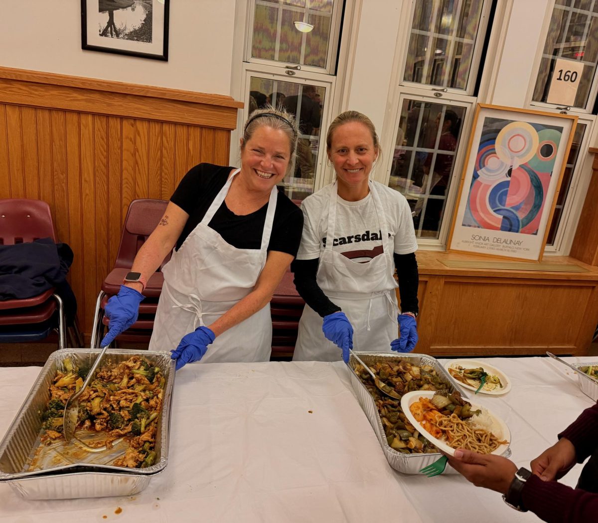 SHS staff serves food.