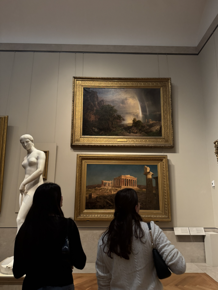 Summer Eichel '26 and Serena Glik '26 admiring multiple works of art.