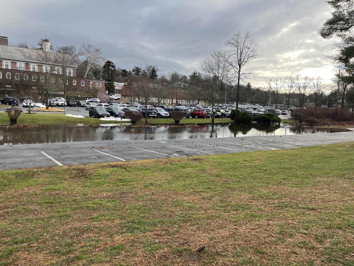 Cars have vacated the parking lot as the creek's water levels rise.