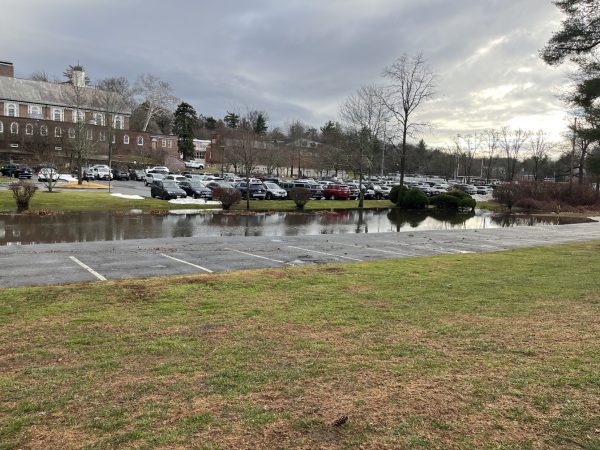 Cars have vacated the parking lot as the creek's water levels rise.