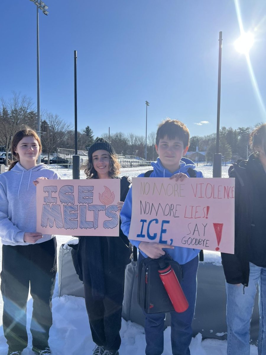SHS students display protest signs outside the school as part of the walkout.
