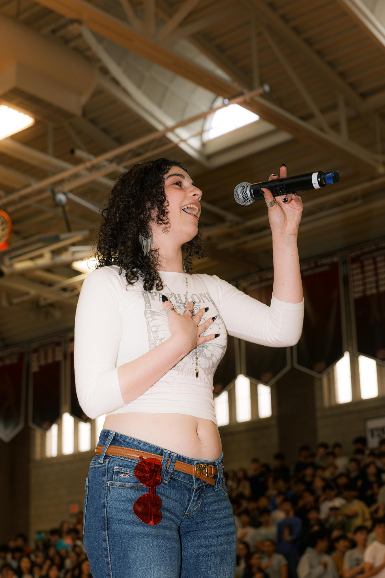 Uma Scher ’26 sings the National Anthem to begin the Pep Rally.